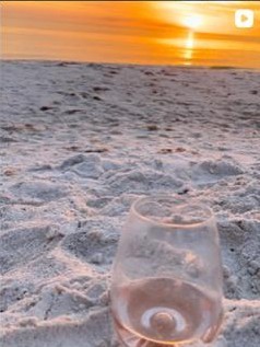 Pale rosé in stemless glass, golden sunset